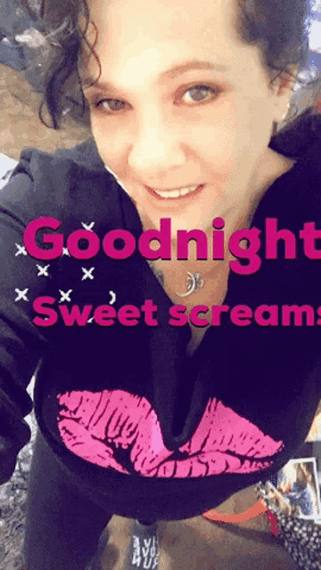 a woman wearing a black shirt with a pink kiss on it says goodnight sweet scream