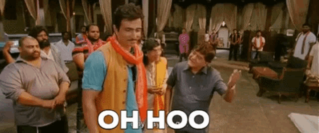 a group of men are standing in a room with the words oh hoo written on the screen