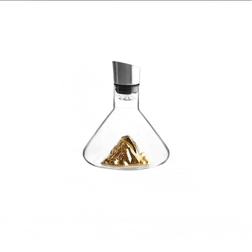 a glass decanter with a mountain in the middle of it