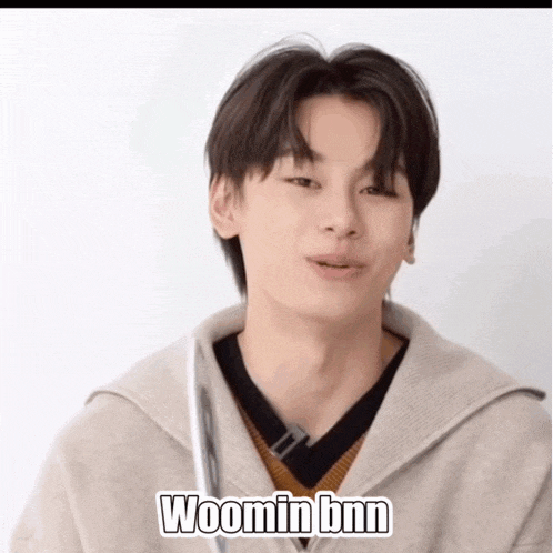 a young man is wearing a sweater and says woomin bnn on the bottom