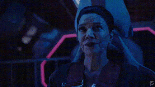 a woman is standing in front of a neon sign that says full