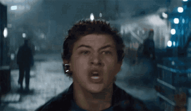 a close up of a young man making a funny face