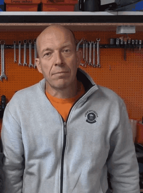a man wearing a grey sweatshirt with a logo on the front that says ' crew expedition '