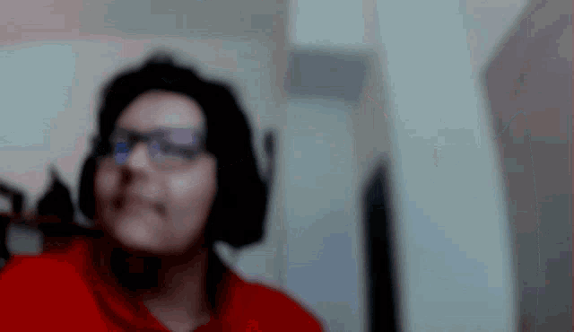 a blurry picture of a woman wearing headphones and glasses