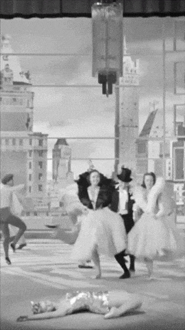 a black and white photo of people dancing in a city