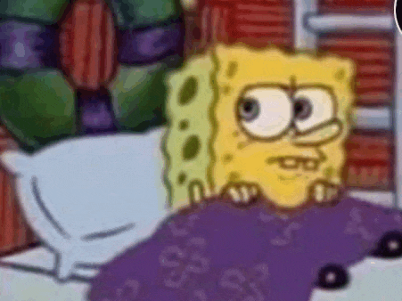a close up of a cartoon character , spongebob squarepants , laying in a bed .