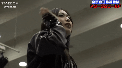 a woman in a black jacket with the word stardom on it