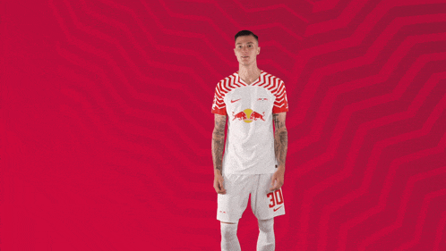 a man in a red and white jersey with the number 30 on his shorts