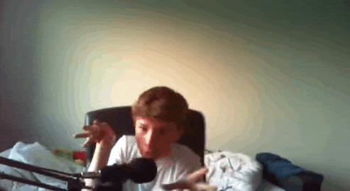 a man is smoking a cigar in front of a microphone