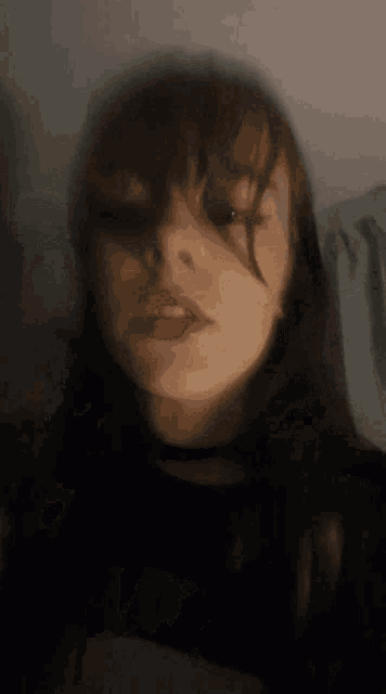 a blurry picture of a girl 's face with a red lip
