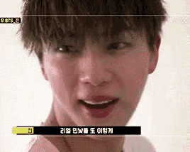 a close up of a young man 's face with korean writing on the bottom