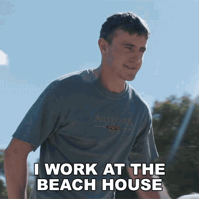 a man in an arizona t-shirt says i work at the beach house