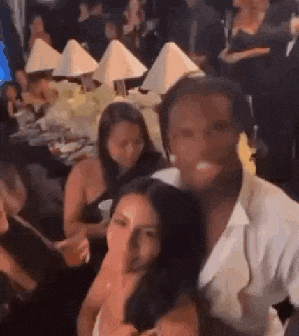 a group of people are sitting at tables in a room .