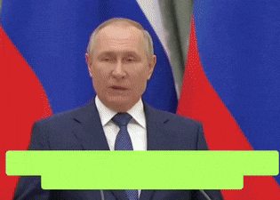 a man in a suit and tie is giving a speech in front of a flag