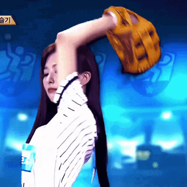 a woman is holding a baseball glove over her head with a blue background and a sign that says ' s '