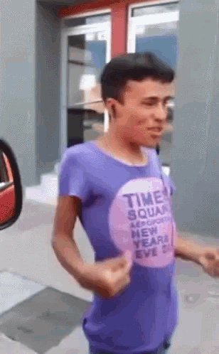 a man in a purple shirt that says time squad on it