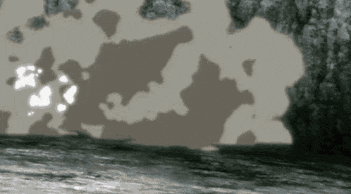 a black and white photo of a body of water surrounded by rocks .