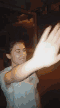 a blurry picture of a person laying down with their hand in the air