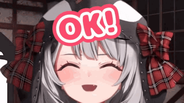 a close up of a girl with a sign that says ok on her head
