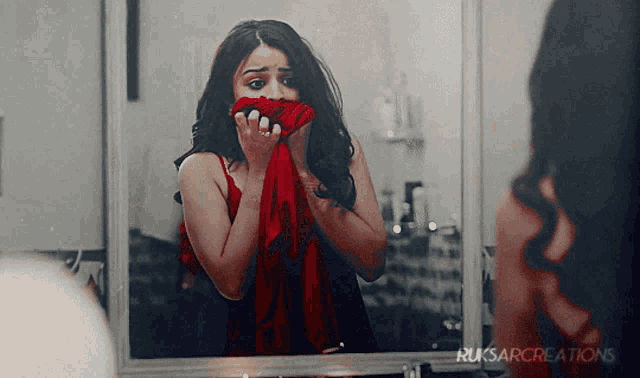 a woman covering her mouth in front of a mirror with the words ruksarcreations on the bottom right