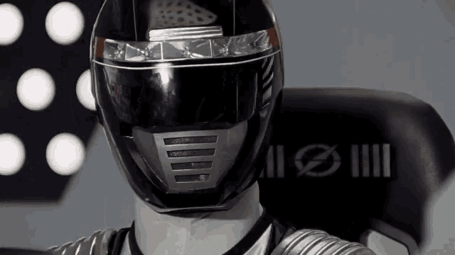 a person wearing a black helmet with a circle on the back of it