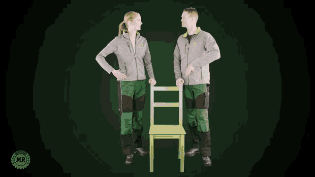 a man and a woman standing next to a green chair with a mr logo in the corner