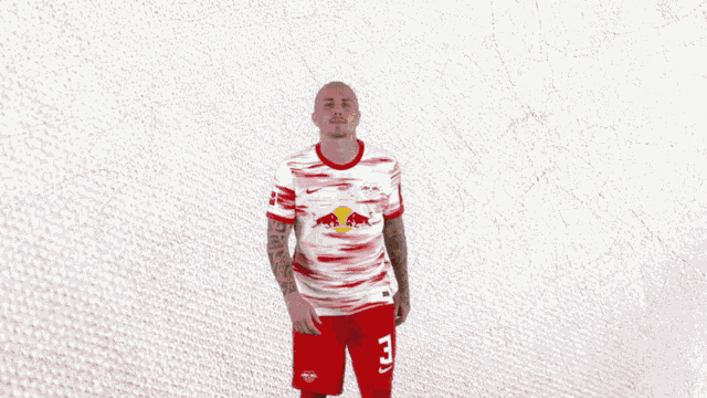 a man wearing a red and white shirt with a bull on it