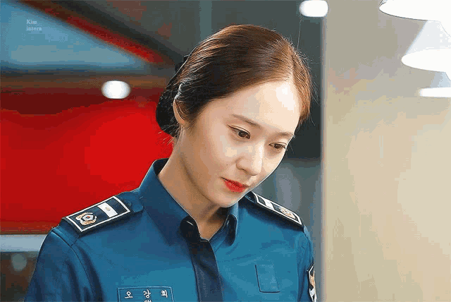 a woman in a police uniform has a name tag that says kim