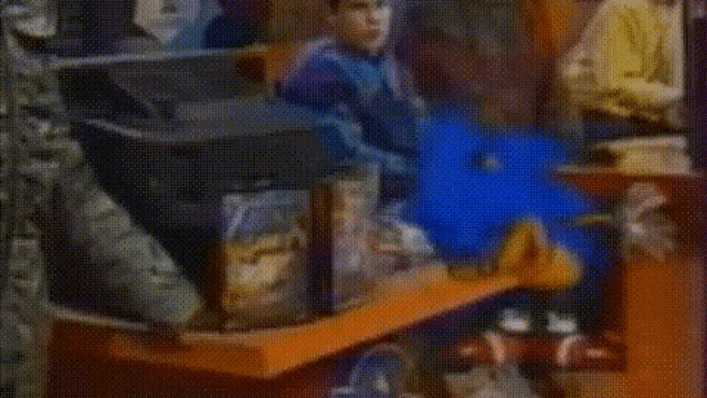 a man is playing a piano next to a stuffed animal in a room .