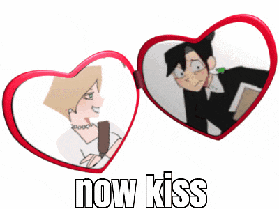 a heart shaped mirror with a picture of a man and woman and the words now kiss