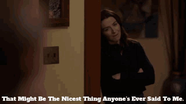 a woman standing in a doorway with a caption that might be the nicest thing anyone 's ever said to me