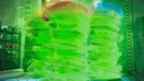 a green smoke coming out of a room with a ladder in the background