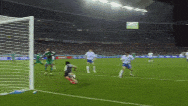 a soccer game is being played in a stadium with a sign that says ' coca cola ' on it
