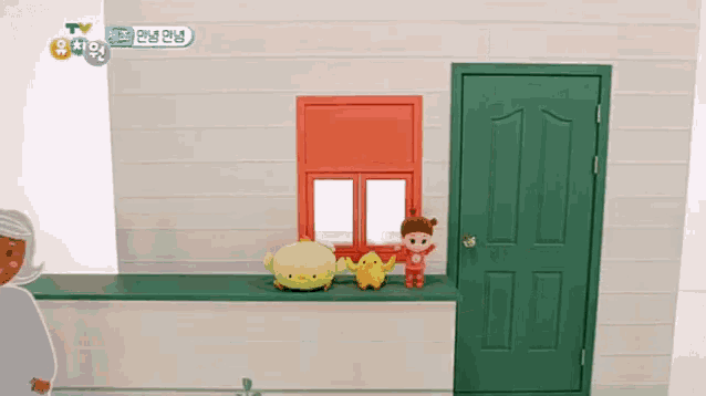 a green door is open to a room with stuffed animals in front of a window