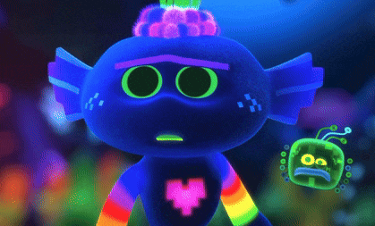 a glow in the dark troll with a rainbow heart on its chest
