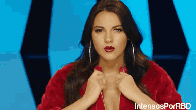 a woman in a red fur coat with intensosporrbd on the bottom right