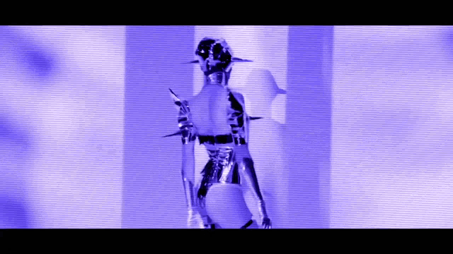 a woman in a futuristic outfit is standing in front of a blue wall