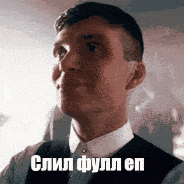 a man in a suit is smiling with a foreign language written on his face
