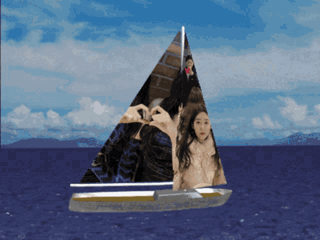 a sailboat with a picture of a woman making a heart shape