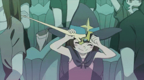 a girl in a witch hat is holding a sword in front of her face