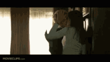 a couple kissing in front of a window with movieclips.com written on the bottom