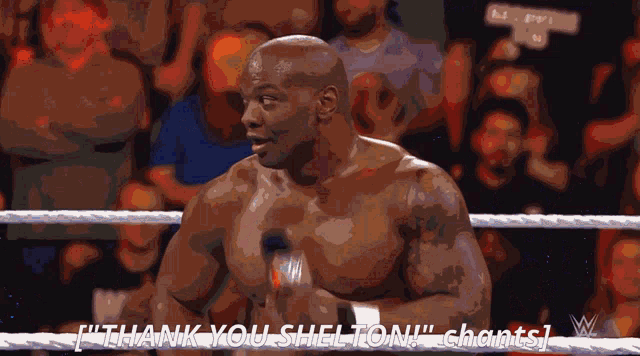 a man in a boxing ring says " thank you shelton " in front of a crowd