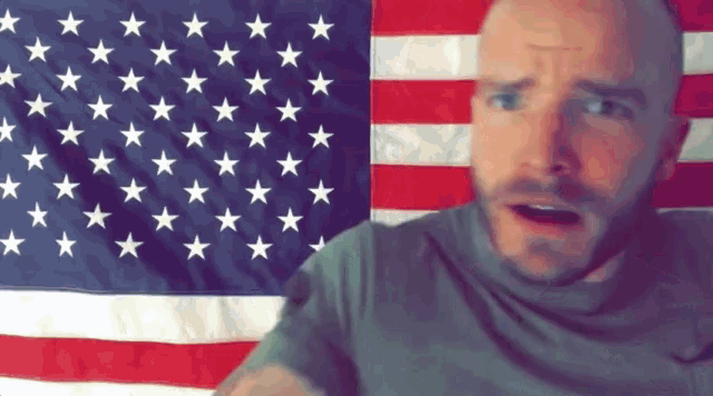 a man stands in front of an american flag with stars
