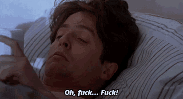a man is laying in bed with the words oh fuck fuck written on the bottom