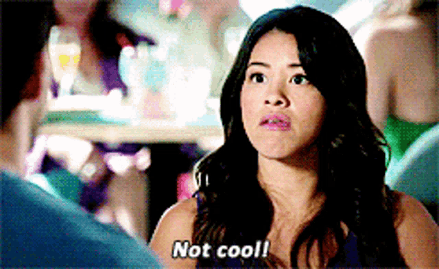 a woman says " not cool " while sitting in a restaurant