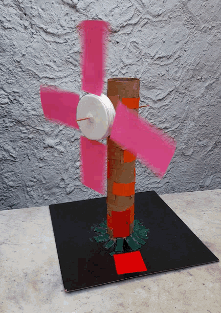 a model of a windmill made out of a cardboard tube