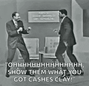 two men in suits are dancing together in a room .
