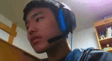 a man wearing headphones with a microphone on his head .