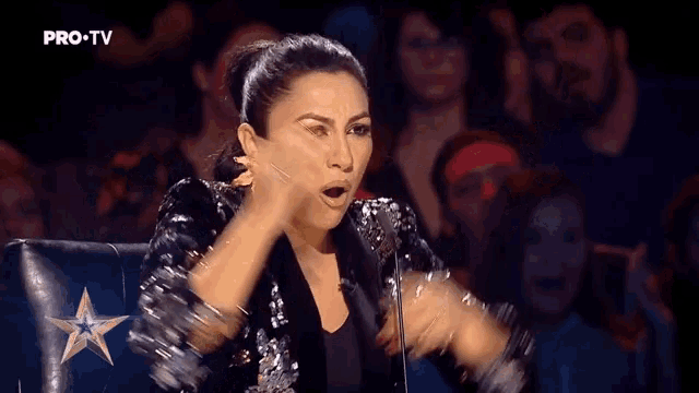 a woman in a sequined jacket is on a pro-tv show
