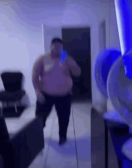 a man is taking a picture of himself in a mirror while dancing in a room .